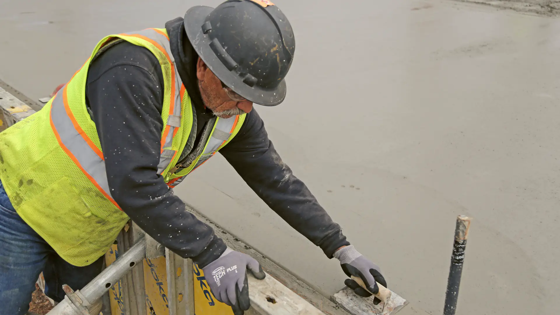 Construction worker in a hard hat working on a building frame